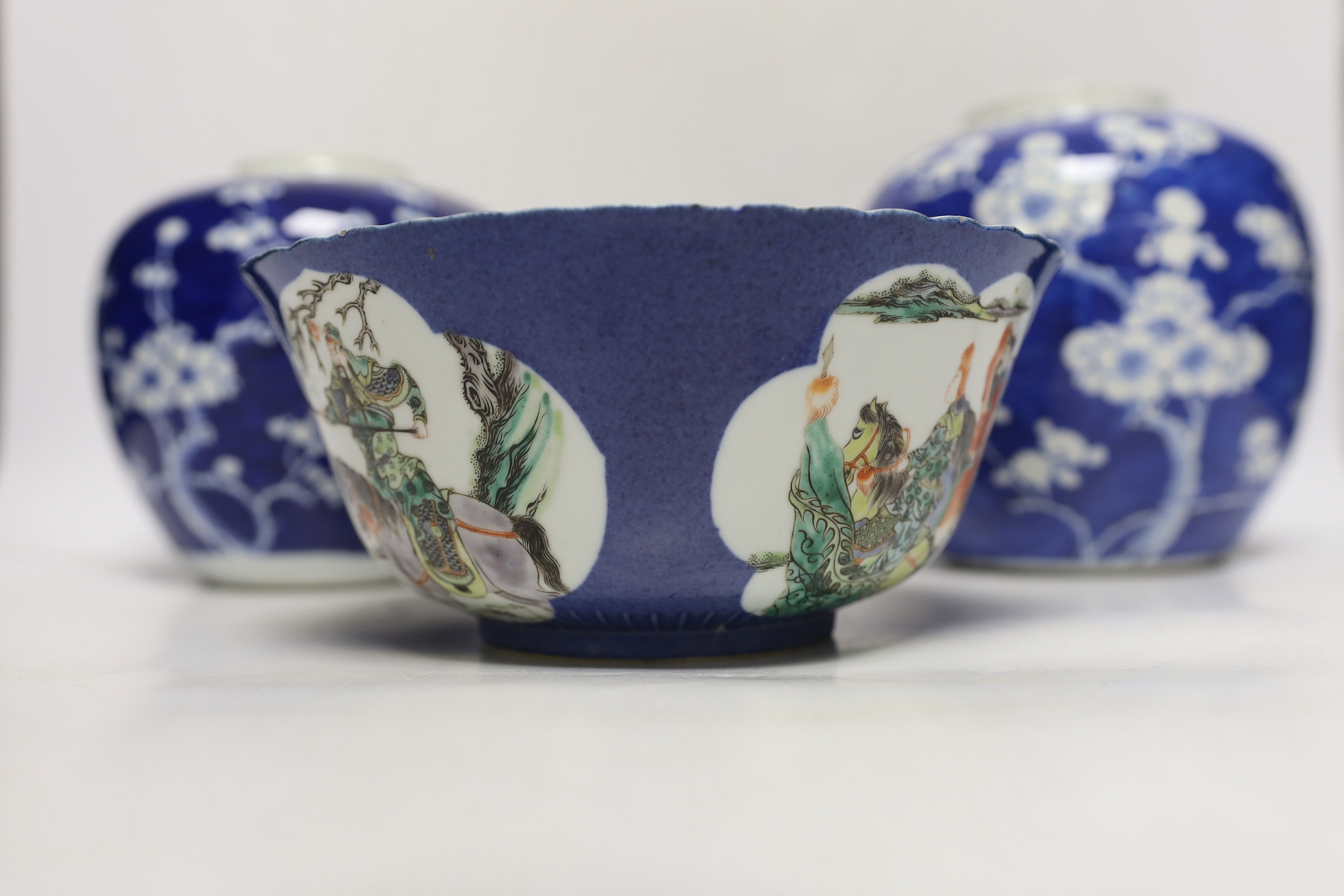 Two Chinese blue and white prunus jars, and a famille verte powder blue bowl, late 19th/early 20th century, tallest 17.5cm